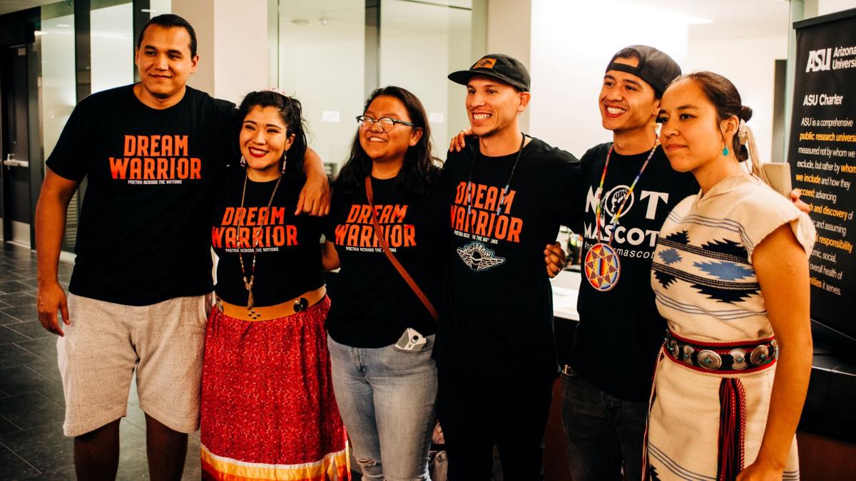 Five people wearing "Dream Warrior" t-shirts pose for a picture.