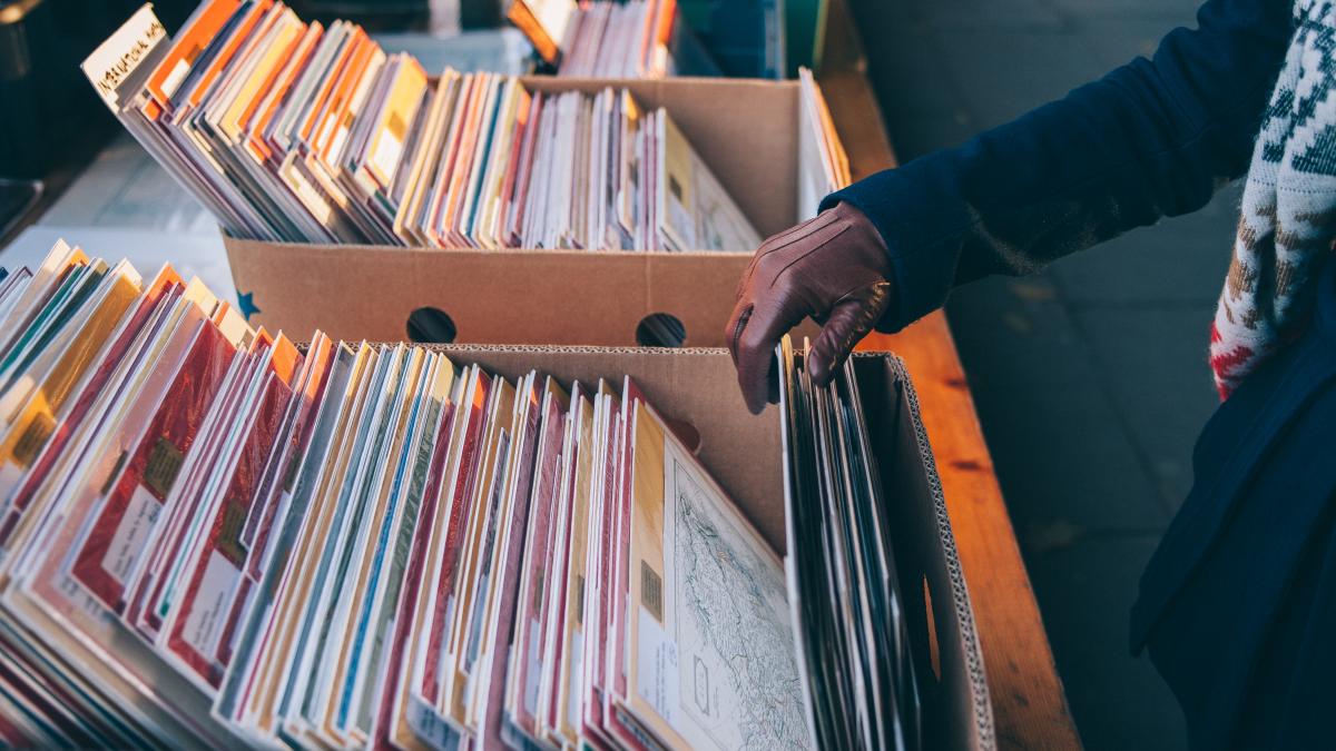 A person looking through boxes of records. 