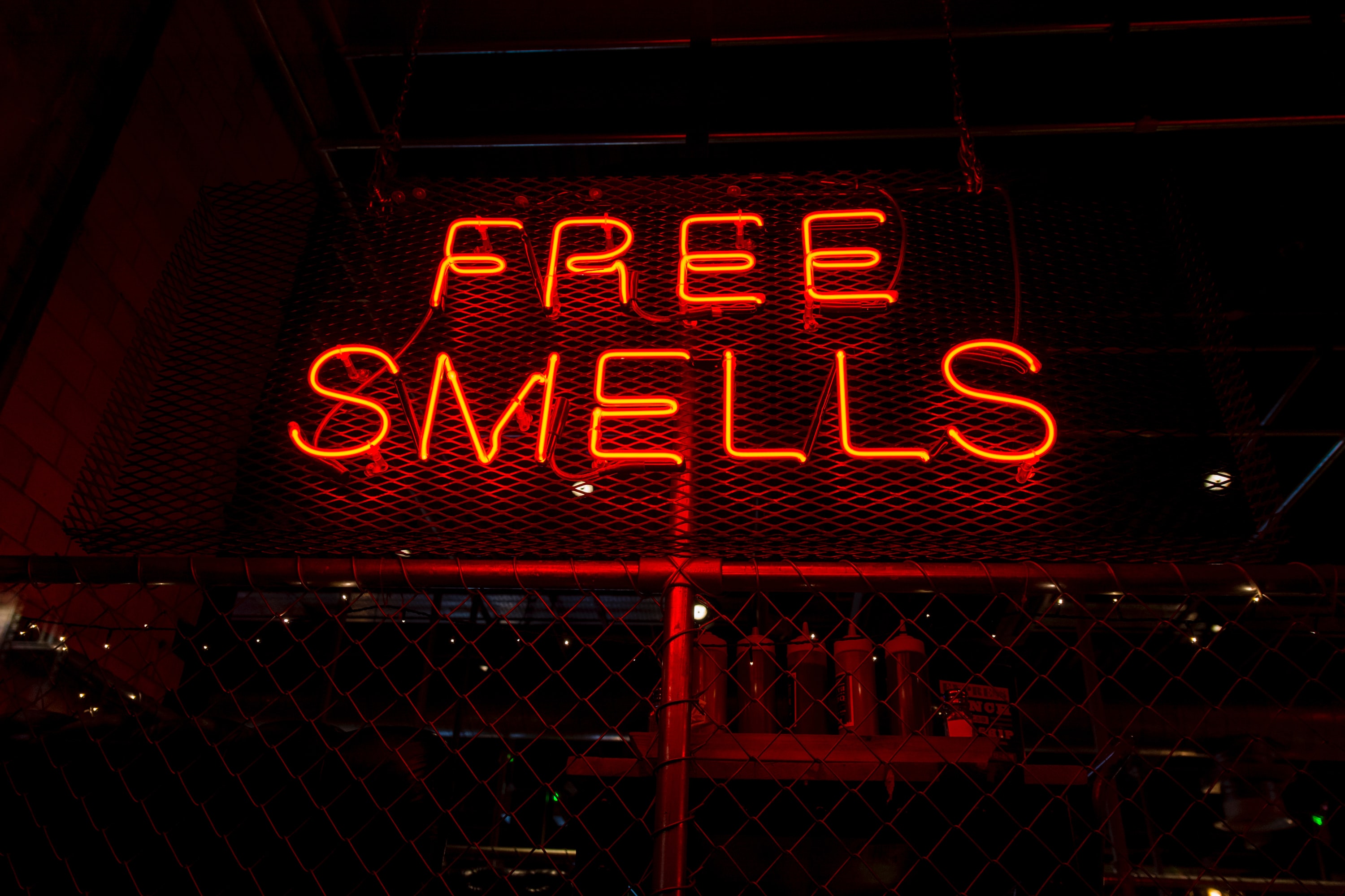 Neon sign "Free Smells" at night