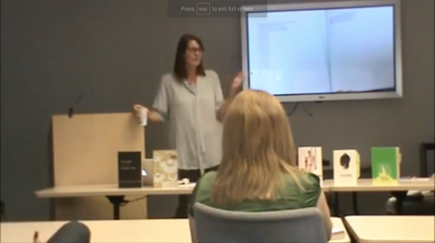 A woman giving a presentation.